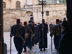 A procession enters the Church of the Holy Sepulchre