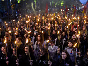 People take part in a torchlight procession