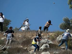 Masked Israeli settlers attack Palestinian olive farmers 