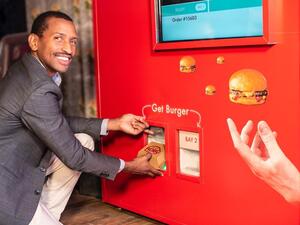 The front of the vending machine features a touchscreen, where customers can select their toppings and condiments
