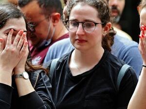 Israelis react at the site of a shooting attack in Tel Aviv 