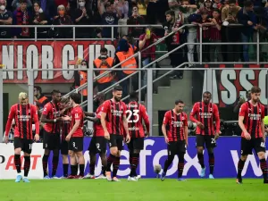 AC Milan's Portuguese forward Rafael Leao (2nd L) celebrates with teammates after scoring his team's first goal during the Italian Serie A football match between AC Milan and Genoa at the Giuseppe Meazza Stadium - also called San Siro in Milan, on April 15, 2022. (Photo by MIGUEL MEDINA / AFP)