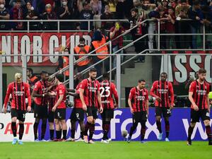 AC Milan's Portuguese forward Rafael Leao (2nd L) celebrates with teammates after scoring his team's first goal during the Italian Serie A football match between AC Milan and Genoa at the Giuseppe Meazza Stadium - also called San Siro in Milan, on April 15, 2022. (Photo by MIGUEL MEDINA / AFP)