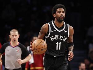 Kyrie Irving #11 of the Brooklyn Nets dribbles during the first half of the Eastern Conference 2022 Play-In Tournament against the Cleveland Cavaliers at Barclays Center on April 12, 2022 in the Brooklyn borough of New York City. (Photo by Sarah Stier / GETTY IMAGES NORTH AMERICA / Getty Images via AFP)