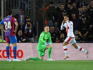 Rayo Vallecano's Spanish midfielder Alvaro Garcia Rivera (R) celebrates after scoring a goal during the Spanish league football match between FC Barcelona and Rayo Vallecano de Madrid at the Camp Nou stadium in Barcelona on April 24, 2022. (Photo by LLUIS GENE / AFP)
