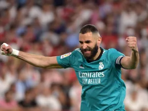 Real Madrid's French forward Karim Benzema celebrates after Real Madrid's Spanish defender Nacho Fernandez scored a goal during the Spanish League football match between Sevilla FC and Real Madrid CF at the Ramon Sanchez Pizjuan stadium in Seville on April 17, 2022. (Photo by CRISTINA QUICLER / AFP)