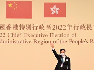 John Lee waves after becoming the city's new chief executive in Hong Kong