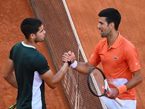 Spain's Carlos Alcaraz (L) and Serbia's Novak Djokovic shake hands at the end of their 2022 ATP Tour Madrid Open tennis tournament men's singles semi-final match at the Caja Magica in Madrid on May 7, 2022. (Photo by GABRIEL BOUYS / AFP) Spain's Carlos Alcaraz (L) and Serbia's Novak Djokovic shake hands at the end of their 2022 ATP Tour Madrid Open tennis tournament men's singles semi-final match at the Caja Magica in Madrid on May 7, 2022. (Photo by GABRIEL BOUYS / AFP)