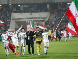 Iran's players celebrate with their fans after qualifying for the 2022 Qatar World Cup after their win against Iraq in the Asian Qualifiers football match at the Azadi Sports Complex in the capital Tehran, on January 27, 2022. (Photo by Atta KENARE / AFP) Iran's players celebrate with their fans after qualifying for the 2022 Qatar World Cup after their win against Iraq in the Asian Qualifiers football match at the Azadi Sports Complex in the capital Tehran, on January 27, 2022. (Photo by Atta KENARE / AFP)