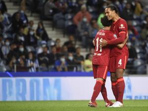 Liverpool's Egyptian forward Mohamed Salah celebrates scoring his team's second goal with Liverpool's Dutch defender Virgil van Dijk during the UEFA Champions League first round group B footbal match between Porto and Liverpool at the Dragao stadium in Porto on September 28, 2021. (Photo by MIGUEL RIOPA / AFP) Liverpool's Egyptian forward Mohamed Salah celebrates scoring his team's second goal with Liverpool's Dutch defender Virgil van Dijk during the UEFA Champions League first round group B footbal match between Porto and Liverpool at the Dragao stadium in Porto on September 28, 2021. (Photo by MIGUEL RIOPA / AFP)