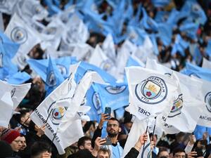Mancherster City's supporters cheers during the UEFA Champions League semi-final first leg football match between Manchester City and Real Madrid, at the Etihad Stadium, in Manchester, on April 26, 2022. (Photo by Oli SCARFF / AFP) Mancherster City's supporters cheers during the UEFA Champions League semi-final first leg football match between Manchester City and Real Madrid, at the Etihad Stadium, in Manchester, on April 26, 2022. (Photo by Oli SCARFF / AFP)