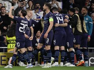 Manchester City players celebrate a goal scored by Manchester City's Algerian midfielder Riyad Mahrez during the UEFA Champions League semi-final second leg football match between Real Madrid CF and Manchester City at the Santiago Bernabeu stadium in Madrid on May 4, 2022. (Photo by JAVIER SORIANO / AFP) Manchester City players celebrate a goal scored by Manchester City's Algerian midfielder Riyad Mahrez during the UEFA Champions League semi-final second leg football match between Real Madrid CF and Manchester City at the Santiago Bernabeu stadium in Madrid on May 4, 2022. (Photo by JAVIER SORIANO / AFP)