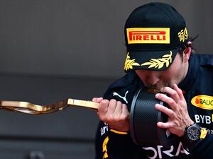 Red Bull Racing's Mexican driver Sergio Perez kisses his trophy on the podium after winning the Monaco Formula 1 Grand Prix at the Monaco street circuit in Monaco, on May 29, 2022. (Photo by SEBASTIEN BOZON / AFP) Red Bull Racing's Mexican driver Sergio Perez kisses his trophy on the podium after winning the Monaco Formula 1 Grand Prix at the Monaco street circuit in Monaco, on May 29, 2022. (Photo by SEBASTIEN BOZON / AFP)