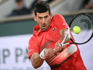 Serbia's Novak Djokovic returns the ball to Spain's Rafael Nadal during their men's quarter-final singles match on day ten of the Roland-Garros Open tennis tournament at the Court Philippe-Chatrier in Paris early on June 1, 2022. (Photo by Anne-Christine POUJOULAT / AFP)