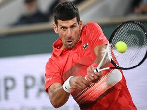 Serbia's Novak Djokovic returns the ball to Spain's Rafael Nadal during their men's quarter-final singles match on day ten of the Roland-Garros Open tennis tournament at the Court Philippe-Chatrier in Paris early on June 1, 2022. (Photo by Anne-Christine POUJOULAT / AFP) Serbia's Novak Djokovic returns the ball to Spain's Rafael Nadal during their men's quarter-final singles match on day ten of the Roland-Garros Open tennis tournament at the Court Philippe-Chatrier in Paris early on June 1, 2022. (Photo by Anne-Christine POUJOULAT / AFP)