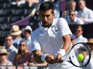 Serbia's Novak Djokovic returns the ball to Canada's Felix Auger-Aliassime during their men's exhibition singles match at The Giorgio Armani Tennis Classic tournament at the Hurlingham Club, in London, on June 22, 2022. (Photo by Adrian DENNIS / AFP)