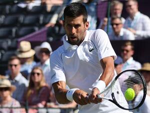Serbia's Novak Djokovic returns the ball to Canada's Felix Auger-Aliassime during their men's exhibition singles match at The Giorgio Armani Tennis Classic tournament at the Hurlingham Club, in London, on June 22, 2022. (Photo by Adrian DENNIS / AFP) Serbia's Novak Djokovic returns the ball to Canada's Felix Auger-Aliassime during their men's exhibition singles match at The Giorgio Armani Tennis Classic tournament at the Hurlingham Club, in London, on June 22, 2022. (Photo by Adrian DENNIS / AFP)