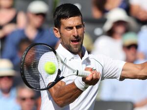 Serbia's Novak Djokovic returns the ball to Canada's Felix Auger-Aliassime during their men's exhibition singles match at The Giorgio Armani Tennis Classic tournament at the Hurlingham Club, in London, on June 22, 2022. (Photo by Adrian DENNIS / AFP) Serbia's Novak Djokovic returns the ball to Canada's Felix Auger-Aliassime during their men's exhibition singles match at The Giorgio Armani Tennis Classic tournament at the Hurlingham Club, in London, on June 22, 2022. (Photo by Adrian DENNIS / AFP)