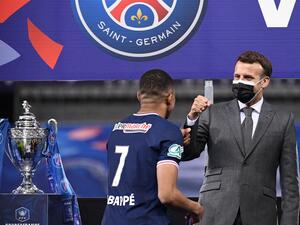 Paris Saint-Germain's French forward Kylian Mbappe is congratulated by French president Emmanuel Macron after winning the French Cup final football match between Paris Saint-Germain and Monaco at the Stade de France stadium, in Saint-Denis, on the outskirts of Paris, on May 19, 2021. / AFP / FRANCK FIFE Paris Saint-Germain's French forward Kylian Mbappe is congratulated by French president Emmanuel Macron after winning the French Cup final football match between Paris Saint-Germain and Monaco at the Stade de France stadium, in Saint-Denis, on the outskirts of Paris, on May 19, 2021. / AFP / FRANCK FIFE