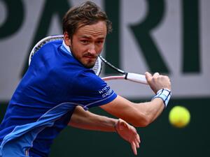 Russia's Daniil Medvedev returns the ball to Argentina's Facundo Bagnis during their men's singles match on day three of the Roland-Garros Open tennis tournament at the Court Suzanne-Lenglen in Paris on May 24, 2022. (Photo by Anne-Christine POUJOULAT / AFP) Russia's Daniil Medvedev returns the ball to Argentina's Facundo Bagnis during their men's singles match on day three of the Roland-Garros Open tennis tournament at the Court Suzanne-Lenglen in Paris on May 24, 2022. (Photo by Anne-Christine POUJOULAT / AFP)