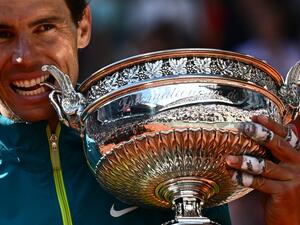 Spain's Rafael Nadal poses with The Musketeers' Cup as he celebrates after victory over Norway's Casper Ruud during their men's singles final match on day fifteen of the Roland-Garros Open tennis tournament at the Court Philippe-Chatrier in Paris on June 5, 2022. (Photo by Anne-Christine POUJOULAT / AFP) Spain's Rafael Nadal poses with The Musketeers' Cup as he celebrates after victory over Norway's Casper Ruud during their men's singles final match on day fifteen of the Roland-Garros Open tennis tournament at the Court Philippe-Chatrier in Paris on June 5, 2022. (Photo by Anne-Christine POUJOULAT / AFP)