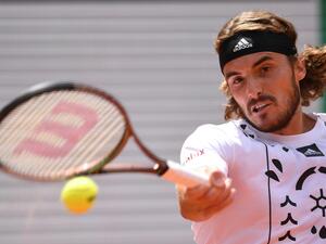 Greece's Stefanos Tsitsipas returns the ball to Denmark's Holger Rune during their men's singles match on day nine of the Roland-Garros Open tennis tournament at the Court Philippe-Chatrier in Paris on May 30, 2022. (Photo by JULIEN DE ROSA / AFP) Greece's Stefanos Tsitsipas returns the ball to Denmark's Holger Rune during their men's singles match on day nine of the Roland-Garros Open tennis tournament at the Court Philippe-Chatrier in Paris on May 30, 2022. (Photo by JULIEN DE ROSA / AFP)