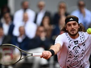 Greece's Stefanos Tsitsipas returns to Denmark's Holger Rune during their men's singles match on day nine of the Roland-Garros Open tennis tournament at the Court Philippe-Chatrier in Paris on May 30, 2022. (Photo by Christophe ARCHAMBAULT / AFP) Greece's Stefanos Tsitsipas returns to Denmark's Holger Rune during their men's singles match on day nine of the Roland-Garros Open tennis tournament at the Court Philippe-Chatrier in Paris on May 30, 2022. (Photo by Christophe ARCHAMBAULT / AFP)