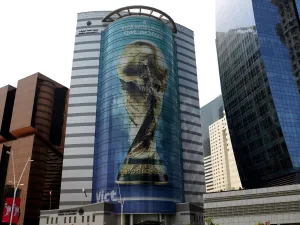 An image of the FIFA 2022 World Cup trophy adorns a building in the Qatari capital Doha on August 16, 2022. (Photo by Mustafa ABUMUNES / AFP)