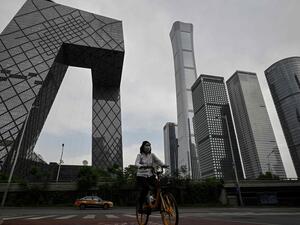 A women cycling in Beijing's business district 