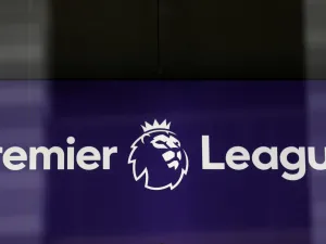The logo is pictured through a glass window at the headquarters of the English Premier League in London on March 13, 2020. / AFP / Isabel Infantes