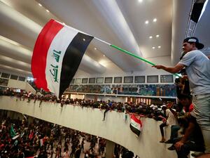 Al Sadr supporter waves flag inside Iraqi Parliament 
