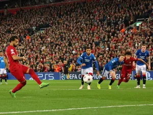 Liverpool's Egyptian striker Mohamed Salah (L) shoots from the penalty spot to score their second goal during UEFA Champions League group A football match between Liverpool and Glasgow Rangers at Anfield in Liverpool, north west England on October 4, 2022. (Photo by Nigel Roddis / AFP)
