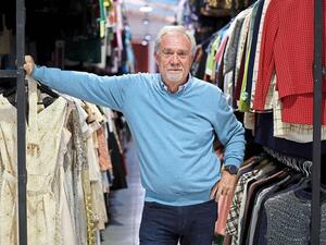 Toledo poses next to costumes 
