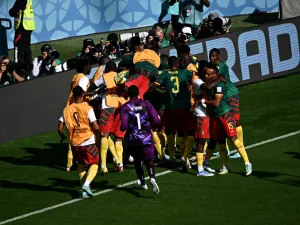 Cameroon's players celebrate after scoring a goal during the Qatar 2022 World Cup Group G football match between Cameroon and Serbia at the Al-Janoub Stadium in Al-Wakrah, south of Doha on November 28, 2022. (Photo by Anne-Christine POUJOULAT / AFP)