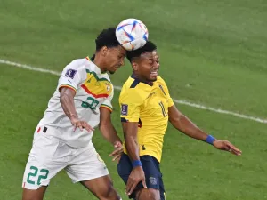 Senegal's defender #22 Abdou Diallo (L) jumps for the ball with Ecuador's forward #11 Michael Estrada during the Qatar 2022 World Cup Group A football match between Ecuador and Senegal at the Khalifa International Stadium in Doha on November 29, 2022. (Photo by JUNG Yeon-je / AFP)