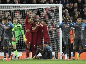 Liverpool's Egyptian striker Mohamed Salah celebrates scoring his team's first goal with teammates during the UEFA Champions League group A football match between Liverpool and Napoli in Liverpool, north west England on November 1, 2022. (Photo by Oli SCARFF / AFP)