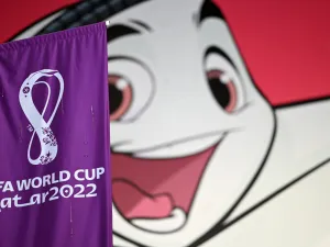 A FIFA banner is displayed in front of a poster of Qatar 2022 mascot La'eeb in Doha on November 7, 2022, ahead of the Qatar 2022 FIFA World Cup football tournament. (Photo by Gabriel BOUYS / AFP)