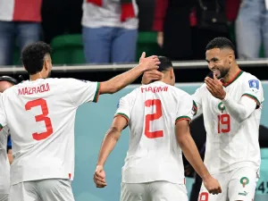 Morocco's forward #19 Youssef En-Nesyri (R) celebrates with Morocco's defender #02 Achraf Hakimi (C) and Morocco's defender #03 Noussair Mazraoui after he scored his team's first goal during the Qatar 2022 World Cup Group F football match between Canada and Morocco at the Al-Thumama Stadium in Doha on December 1, 2022. (Photo by NATALIA KOLESNIKOVA / AFP)
