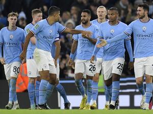 Manchester City's Algerian midfielder Riyad Mahrez (C) celebrates scoring the team's second goal during the English League Cup fourth round football match between Manchester City and Liverpool, at the Etihad stadium in Manchester on December 22, 2022. (Photo by Oli SCARFF / AFP)