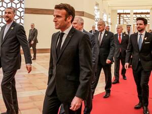 Macron flanked by....