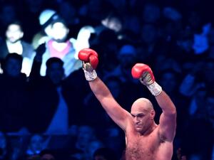 Britain's Tyson Fury reacts after the referee stops the fight against Britain's Derek Chisora during their WBC heavyweight title boxing match, at the Tottenham Hotspur stadium in east London, on December 3, 2022. (Photo by Ben Stansall / AFP)