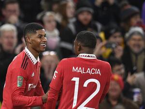 Manchester United's English striker Marcus Rashford (L) celebrates after scoring his team second goal during the English League Cup fourth round football match between Manchester United and Burnley, at Old Trafford, in Manchester, on December 21, 2022. (Photo by Oli SCARFF / AFP)