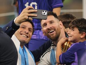 Argentina's captain and forward #10 Lionel Messi poses for a picture with Argentine former footballer Javier Zanetti after Argentina won the Qatar 2022 World Cup final football match between Argentina and France at Lusail Stadium in Lusail, north of Doha on December 18, 2022. (Photo by Adrian DENNIS / AFP)