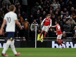 Arsenal's Norwegian midfielder Martin Odegaard (C) celebrates scoring the team's second goal during the English Premier League football match between Tottenham Hotspur and Arsenal at Tottenham Hotspur Stadium in London, on January 15, 2023. (Photo by ADRIAN DENNIS / AFP)