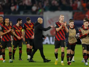 Manchester City's players including Norwegian striker Erling Haaland (C) and Manchester City's Spanish manager Pep Guardiola go over to their fans after the UEFA Champions League round of 16, first-leg football match between RB Leipzig and Manchester City in Leipzig, eastern Germany on February 22, 2023. (Photo by Odd ANDERSEN / AFP)