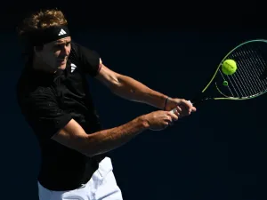 Germany's Alexander Zverev hits a return against Michael Mmoh of the US during their men's singles match on day four of the Australian Open tennis tournament in Melbourne on January 19, 2023. (Photo by Manan VATSYAYANA / AFP)