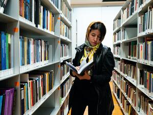 Afghan refugee and activist for women's rights Fatima Haidari reads a book at Bocconi University in Milan, Italy, on February 7, 2023.