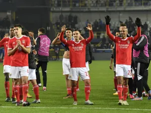Benfica's players celebrate their victory at the end of the UEFA Champions League round of sixteen first leg football match between Bruges (Club Brugge) and Benfica Lisbon at Jan-Breydel Stadion in Bruges, on February 15, 2023. (Photo by JOHN THYS / AFP)