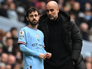 Manchester City's Spanish manager Pep Guardiola (R) speaks with Manchester City's Portuguese midfielder Bernardo Silva (L) before bringing him on as a substitute during the English Premier League football match between Manchester City and Newcastle United at the Etihad Stadium in Manchester, north west England, on March 4, 2023. (Photo by Paul ELLIS / AFP) 