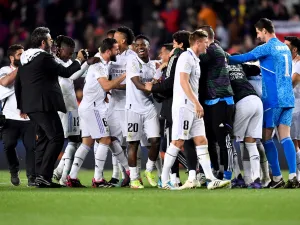 Real Madrid's players celebrate at the end of the Copa del Rey (King's Cup) semi-final second leg football match between FC Barcelona and Real Madrid CF at the Camp Nou stadium in Barcelona on April 5, 2023. (Photo by Pau BARRENA / AFP)